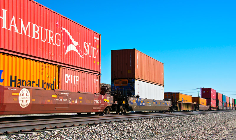 Railroad train freight container carrier