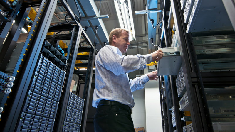 An IT administrator installs a new rackmount server in server room.