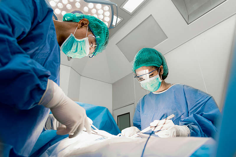 Doctor and nurse with tools in their hands in a operating room.