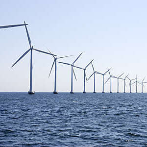 Row of wind turbines at sea off the coast of Copenhagen, Denmark.