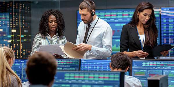 People looking busy in a corporate trading room.