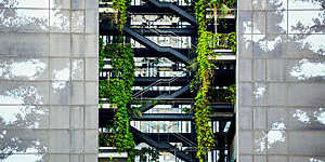 Vegetation grows out of the different levels of a plant-covered building in Barcelona, Spain.