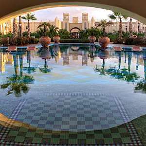 Rui Tourag hotel in the Cape Verde islands with its Moorish style architecture, palm trees and a tiled reflecting pool.
