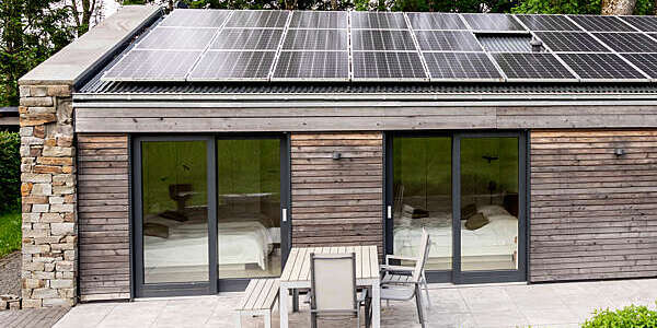 Detached house with solar panels on the roof.