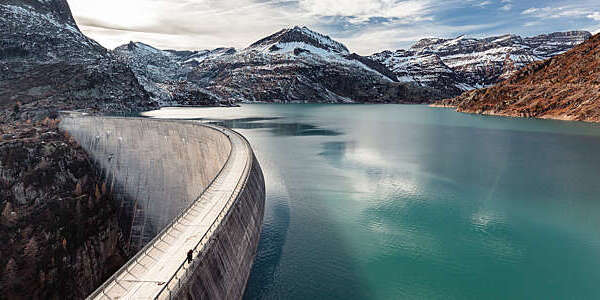 Emosson hydroelectric dam and lake surrounded by rocky landscape, in Switzerland.