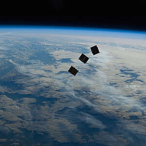 Three small deployed satellites.