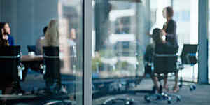 Glass, window and people in boardroom with presentation for business meeting, feedback and training. Corporate, communication and employee with partnership for project, collaboration and b2b workshop