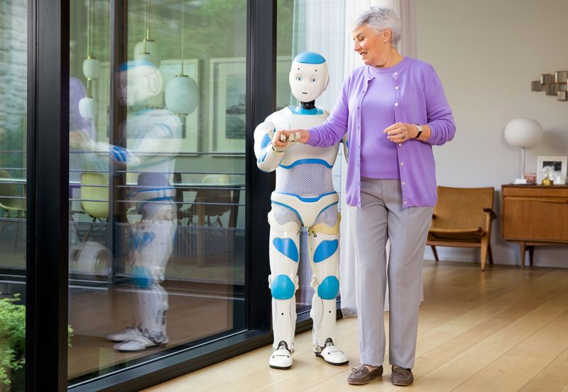 Romeo helping an elderly woman to walk