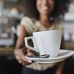 Woman serving a cup of coffee